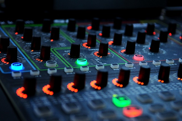 a DJ mixer with neon colored lights